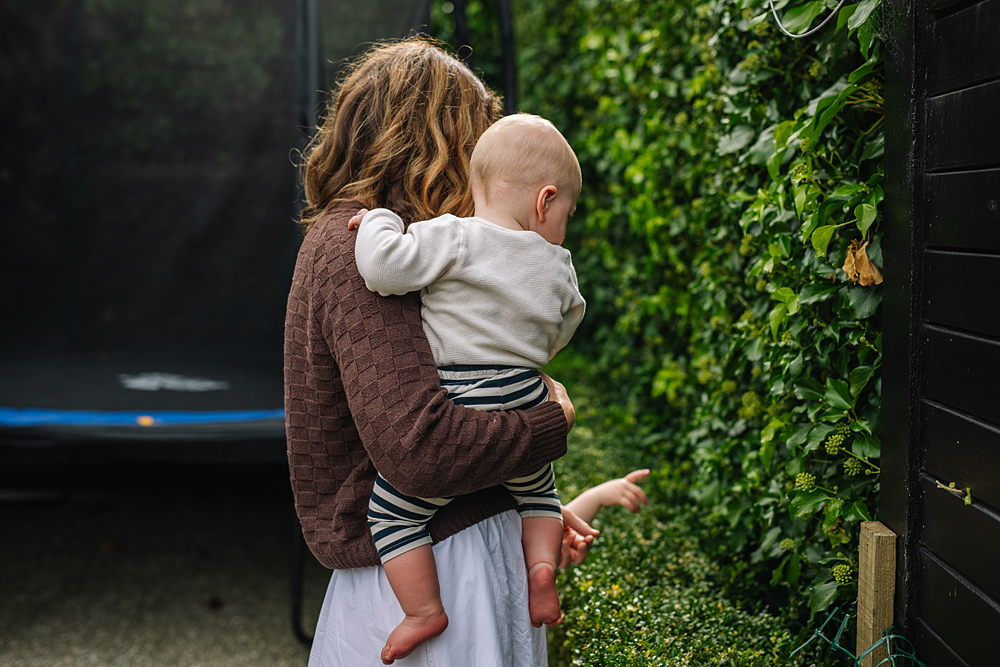Abby Highton carrying her baby through the garden